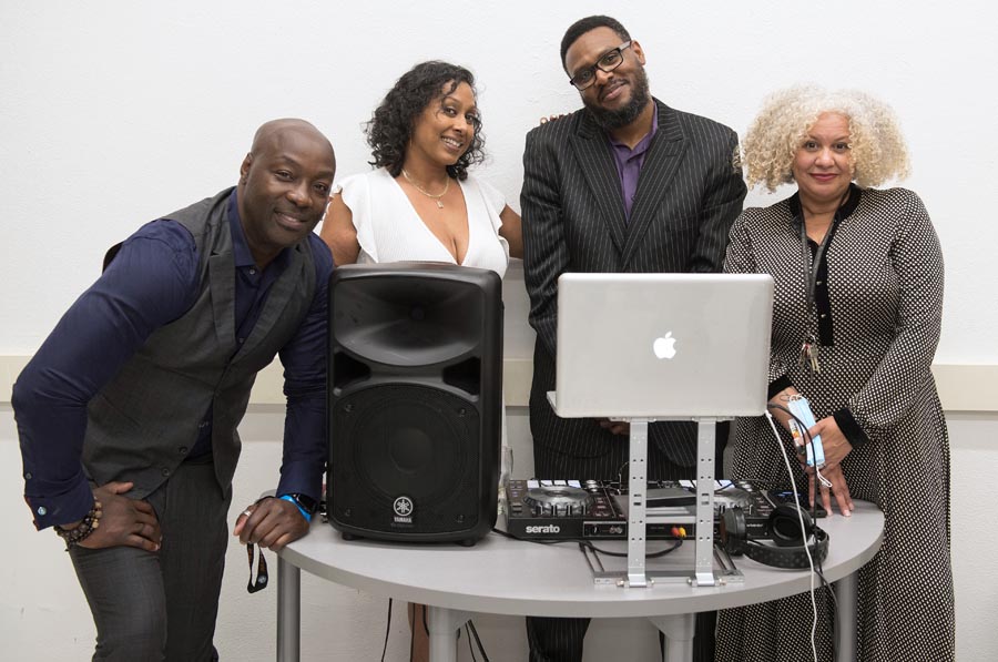 TDSB staff smiling at dj booth. Open Gallery